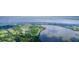 Stunning aerial view of a community by the lake, showcasing the golf course and expansive landscapes at 10614 Low Oak Terrace, Thonotosassa, FL 33592