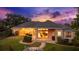 Backyard with covered patio and cozy fire pit, surrounded by lush landscaping and offering outdoor enjoyment at 10614 Low Oak Terrace, Thonotosassa, FL 33592