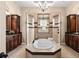 Luxurious bathroom with a soaking tub, tile surround, and custom cabinetry at 10614 Low Oak Terrace, Thonotosassa, FL 33592