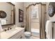 Bathroom features an ornate mirror and a curtained shower at 10614 Low Oak Terrace, Thonotosassa, FL 33592