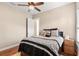 A stylish bedroom boasts natural light, ceiling fan, and wood-look floors at 10614 Low Oak Terrace, Thonotosassa, FL 33592