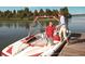 Personal and Personal on a boat on the lake, enjoying the waterfront lifestyle at 10614 Low Oak Terrace, Thonotosassa, FL 33592