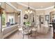 Breakfast nook with a chandelier, glass table and chairs, and views leading to an entryway at 10614 Low Oak Terrace, Thonotosassa, FL 33592