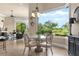 Breakfast nook featuring a glass table and a large window with views of the green outdoors at 10614 Low Oak Terrace, Thonotosassa, FL 33592