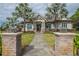 Inviting clubhouse exterior featuring palm trees, stone accents, and a welcoming entrance at 10614 Low Oak Terrace, Thonotosassa, FL 33592