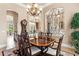 Elegant dining room showcasing a chandelier and decorative ironwork, leading to other rooms at 10614 Low Oak Terrace, Thonotosassa, FL 33592