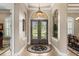 Elegant foyer showcasing a decorative iron door, arched doorways, and high ceilings at 10614 Low Oak Terrace, Thonotosassa, FL 33592