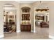 Hallway showcasing a seamless transition to the dining room, bar, and kitchen area at 10614 Low Oak Terrace, Thonotosassa, FL 33592
