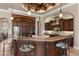 Spacious kitchen features custom cabinetry, granite countertops, and a large island with seating at 10614 Low Oak Terrace, Thonotosassa, FL 33592