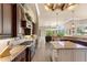 Bright, spacious kitchen features custom cabinetry, granite countertops, and an island with additional seating at 10614 Low Oak Terrace, Thonotosassa, FL 33592