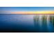 Scenic lake view with serene waters and a colorful sunset in the background at 10614 Low Oak Terrace, Thonotosassa, FL 33592