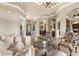 Spacious living room with tile flooring, elegant furnishings, and arched doorways at 10614 Low Oak Terrace, Thonotosassa, FL 33592
