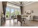 Bright and open living room with tile floors, elegant furnishings, and views of the landscaped backyard at 10614 Low Oak Terrace, Thonotosassa, FL 33592