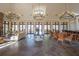 Elegant lobby featuring chandeliers, stone floors, comfortable seating, and ample natural light at 10614 Low Oak Terrace, Thonotosassa, FL 33592