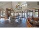Spacious lobby with stone floors, a fireplace, and comfortable seating areas with elegant chandeliers at 10614 Low Oak Terrace, Thonotosassa, FL 33592