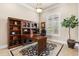 Spacious home office with built-in shelves, a large desk, and a window providing natural light at 10614 Low Oak Terrace, Thonotosassa, FL 33592