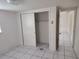 This neutral bedroom features tile floors, a closet, and a ceiling light, awaiting personalized touches at 1155 Royalwood Dr, Holiday, FL 34690