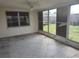 This neutral patio boasts tile floors and multiple windows, offering a versatile and bright space at 1155 Royalwood Dr, Holiday, FL 34690