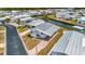Aerial view of the property featuring a metal roof, driveway, landscaping, and proximity to the canal at 119 E Saint Johns Way, Apollo Beach, FL 33572