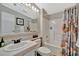 This bathroom offers a full tub and shower combination along with a large framed mirror and single sink vanity at 119 E Saint Johns Way, Apollo Beach, FL 33572