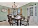 Beautiful dining room featuring a wooden table, stylish chandelier, and display cabinet at 119 E Saint Johns Way, Apollo Beach, FL 33572