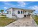 Charming one-story house featuring a carport, and a well-kept front yard at 119 E Saint Johns Way, Apollo Beach, FL 33572