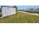 Exterior of the property's canal front storage shed with waterway views at 119 E Saint Johns Way, Apollo Beach, FL 33572