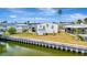 Waterfront home featuring vinyl siding, a storage shed, and scenic canal views at 119 E Saint Johns Way, Apollo Beach, FL 33572