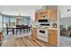 This kitchen features a stove top, wooden cabinets and drawers, and a view of the dining room at 119 E Saint Johns Way, Apollo Beach, FL 33572