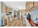 Bright kitchen featuring wood-look vinyl floors, wooden cabinets, modern appliances, and ample countertop space at 119 E Saint Johns Way, Apollo Beach, FL 33572