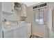 This laundry room has a washer and dryer hookup with storage cabinets and access to the side of the home at 119 E Saint Johns Way, Apollo Beach, FL 33572