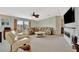 Spacious living room with comfortable couches, ceiling fan, and fireplace at 119 E Saint Johns Way, Apollo Beach, FL 33572