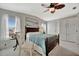 The primary bedroom features a leafy ceiling fan, large picture window and ample storage at 119 E Saint Johns Way, Apollo Beach, FL 33572