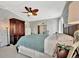 This primary bedroom features a leafy ceiling fan, neutral walls and carpet, and a mirrored closet at 119 E Saint Johns Way, Apollo Beach, FL 33572