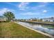 Waterfront view of tranquil canal, docks, and nearby residences under a blue sky with scattered clouds at 119 E Saint Johns Way, Apollo Beach, FL 33572