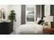 Inviting bedroom featuring a comfortable bed, side table with lamps, a dresser, and a plant for a fresh touch at 12716 Lily Quartz Loop, Parrish, FL 34219