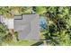 Aerial view of the home featuring a screened pool and lush landscaping at 12712 Stanwyck Cir, Tampa, FL 33626