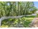Large backyard featuring a white picket fence and ample greenery at 12712 Stanwyck Cir, Tampa, FL 33626