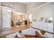 Open-concept dining area flows seamlessly into the living space with a stylish chandelier and wood floors at 12712 Stanwyck Cir, Tampa, FL 33626