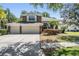 Charming two-story home with a three car garage and decorative stone accents at 12712 Stanwyck Cir, Tampa, FL 33626