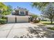Charming two-story home with a three car garage and decorative stone accents at 12712 Stanwyck Cir, Tampa, FL 33626