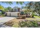 Charming home with a well-maintained front yard and a three-car garage at 12712 Stanwyck Cir, Tampa, FL 33626