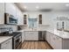 Clean kitchen featuring stainless steel appliances, white cabinets, and quartz countertops at 12712 Stanwyck Cir, Tampa, FL 33626