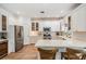 Bright, modern kitchen with white cabinets, stainless appliances, and a large center island at 12712 Stanwyck Cir, Tampa, FL 33626