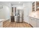 Modern kitchen showcasing a wine cooler, stainless steel refrigerator, and ample cabinet space at 12712 Stanwyck Cir, Tampa, FL 33626