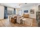 Cozy living room showcasing a stone fireplace, wood floors, and a view to the entry hallway at 12712 Stanwyck Cir, Tampa, FL 33626