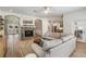 Open-concept living room flows into the kitchen with a fireplace, comfortable seating, and ample natural light at 12712 Stanwyck Cir, Tampa, FL 33626