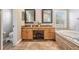 Main bathroom with double vanities, soaker tub and tile flooring at 12712 Stanwyck Cir, Tampa, FL 33626