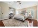 Spacious main bedroom featuring hardwood floors, ceiling fan, and adjacent office at 12712 Stanwyck Cir, Tampa, FL 33626