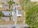Aerial view of a property with a fenced yard, two buildings, tropical landscaping, and parking at 1322 Idlewild Dr, Clearwater, FL 33755